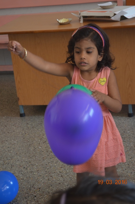 Lia playing with balloon 
